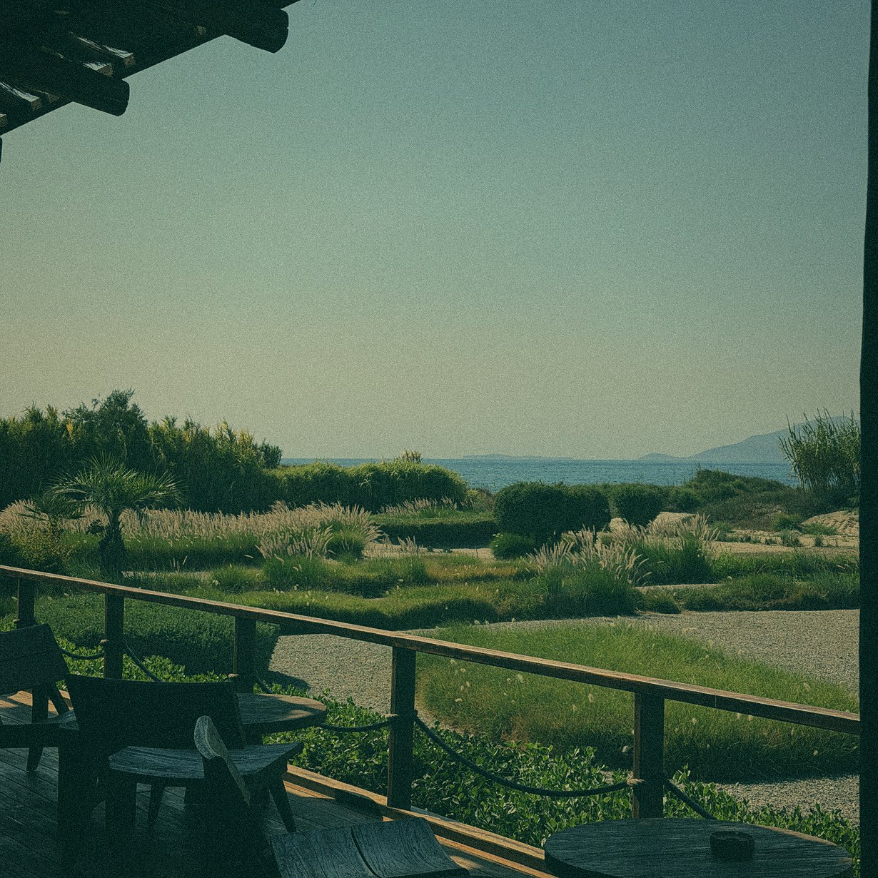 Terrace with wooden chairs overlooking the sea
