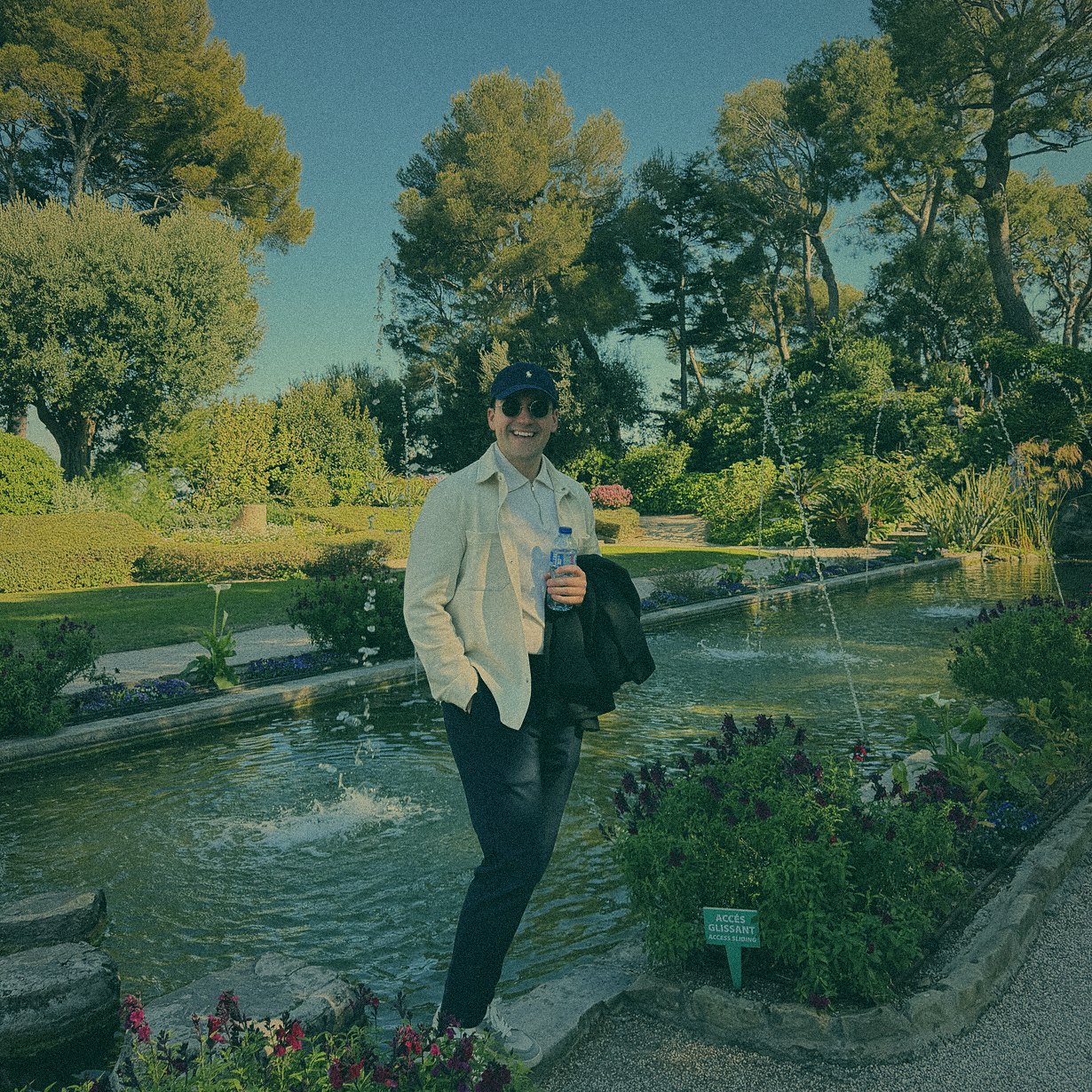 Simon Rico in a white jacket in a Mediterranean garden